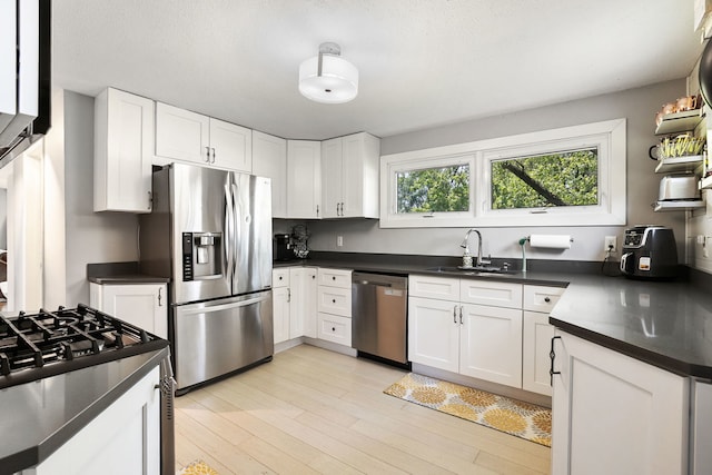 41W822 Burlington Rd, Saint Charles, IL 60175 - kitchen featuring appliances with stainless steel finishes, dark countertops, white cabinets, and light wood-type flooring
