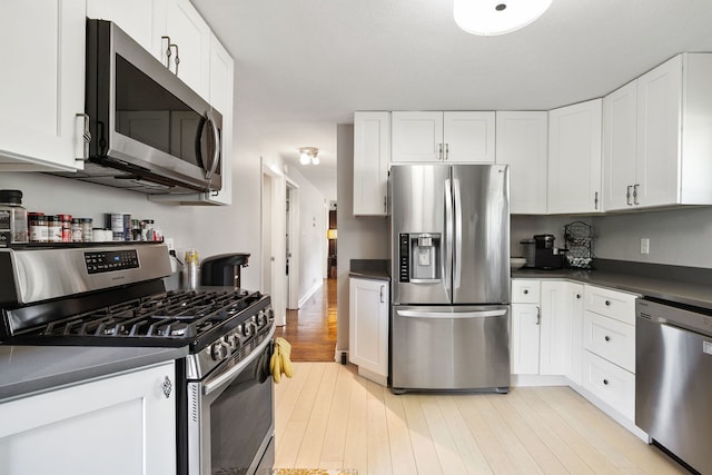 41W822 Burlington Rd, Saint Charles, IL 60175 - kitchen featuring stainless steel appliances, dark countertops, and white cabinetry