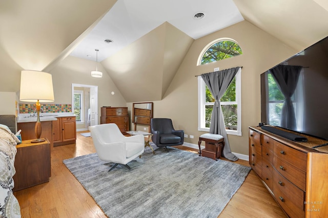 275 S Mchenry Ave, Crystal Lake, IL 60014 - living room with vaulted ceiling, light wood-style floors, plenty of natural light, and baseboards