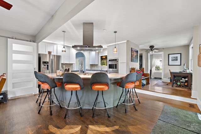 275 S Mchenry Ave, Crystal Lake, IL 60014 - kitchen with island range hood, a ceiling fan, backsplash, white cabinetry, and dark wood-style floors