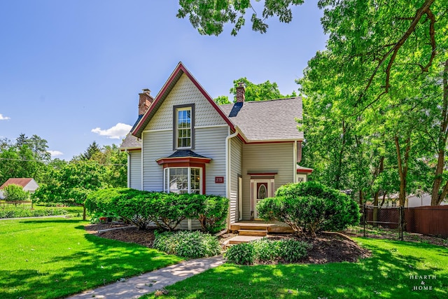 275 S Mchenry Ave, Crystal Lake, IL 60014 - victorian home featuring a chimney and a shingled roof