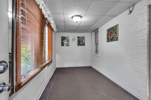 3134 N New England Ave, Chicago, IL 60634 - hall with a paneled ceiling, dark colored carpet, and brick wall