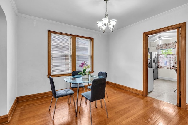 3134 N New England Ave, Chicago, IL 60634 - dining space featuring light wood-type flooring, a chandelier, ornamental molding, arched walkways, and ceiling fan