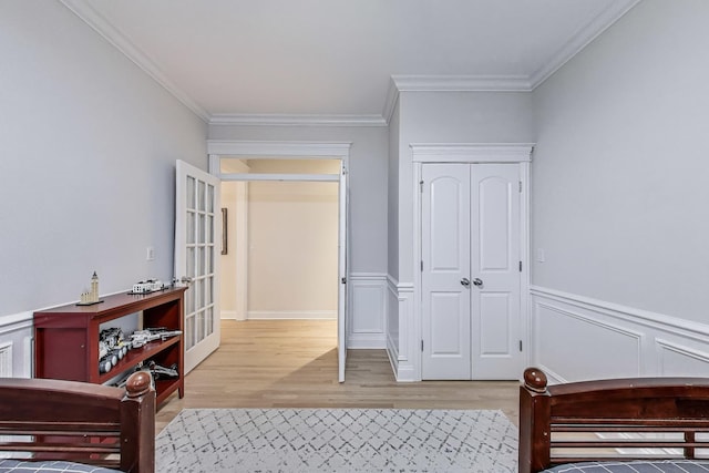5021 N Kenmore Ave Unit 1S, Chicago, IL 60640 - bedroom featuring wood finished floors, ornamental molding, wainscoting, a closet, and french doors