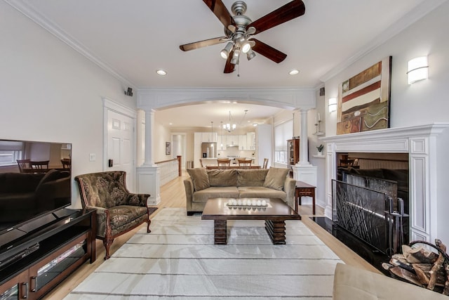 5021 N Kenmore Ave Unit 1S, Chicago, IL 60640 - living area featuring decorative columns, crown molding, ceiling fan, light wood-style flooring, and arched walkways