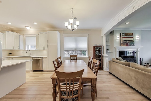 5021 N Kenmore Ave Unit 1S, Chicago, IL 60640 - dining area featuring ornamental molding, healthy amount of natural light, light wood-style flooring, a chandelier, and recessed lighting