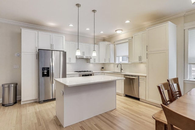 5021 N Kenmore Ave Unit 1S, Chicago, IL 60640 - kitchen with stainless steel appliances, a center island, light wood-style flooring, ornamental molding, and backsplash