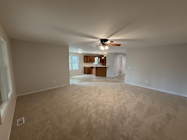 320 S Marguerite St, Coal City, IL 60416 - unfurnished living room with ceiling fan, light carpet, and baseboards