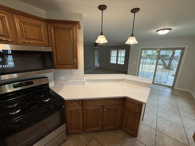 320 S Marguerite St, Coal City, IL 60416 - kitchen with appliances with stainless steel finishes, a peninsula, ceiling fan, light tile patterned flooring, and pendant lighting
