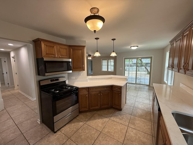 320 S Marguerite St, Coal City, IL 60416 - kitchen featuring stainless steel appliances, a peninsula, light tile patterned floors, hanging light fixtures, and recessed lighting