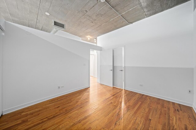 1150 W 15th St Unit 232, Chicago, IL 60608 - unfurnished room featuring wood finished floors and baseboards