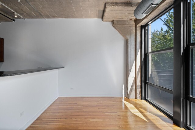 1150 W 15th St Unit 232, Chicago, IL 60608 - unfurnished dining area with wood finished floors and baseboards