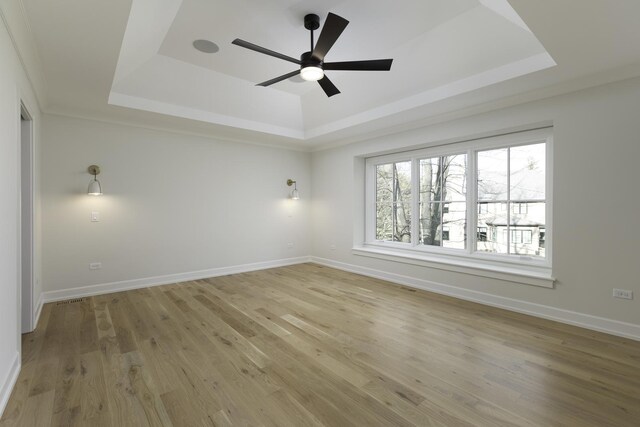 845 Tulip Ln, Naperville, IL 60540 - empty room featuring a tray ceiling, light wood-style flooring, ceiling fan, and baseboards