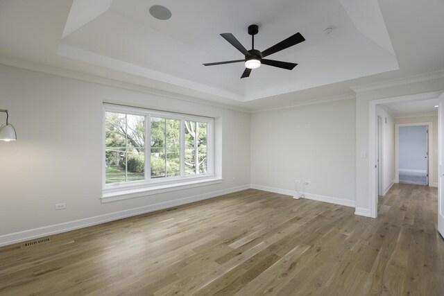 845 Tulip Ln, Naperville, IL 60540 - unfurnished room with a raised ceiling, a ceiling fan, light wood-style flooring, crown molding, and baseboards