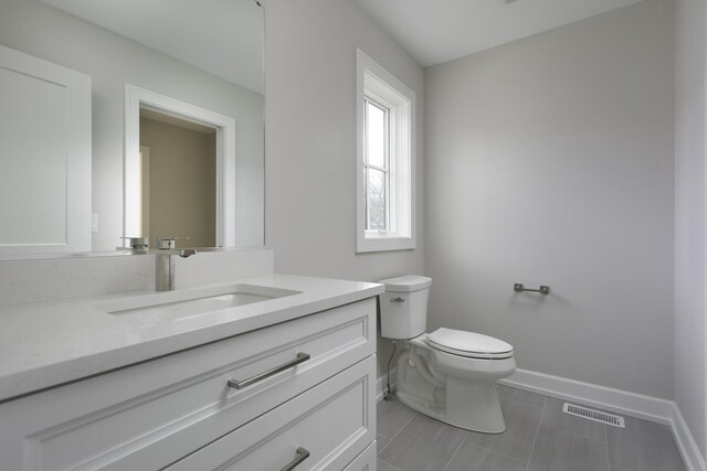 845 Tulip Ln, Naperville, IL 60540 - bathroom with toilet, vanity, and baseboards