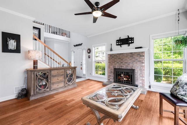 2119 Ivy Ridge Dr Unit 2119, Hoffman Estates, IL 60192 - living room featuring ceiling fan, wood finished floors, a fireplace, crown molding, and stairs