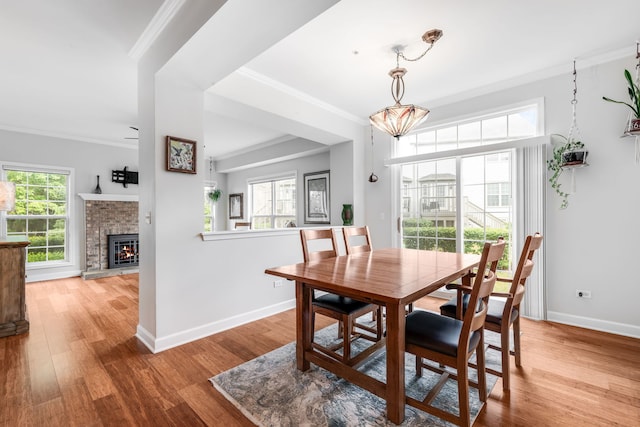 2119 Ivy Ridge Dr Unit 2119, Hoffman Estates, IL 60192 - dining space with wood finished floors, ornamental molding, and a fireplace