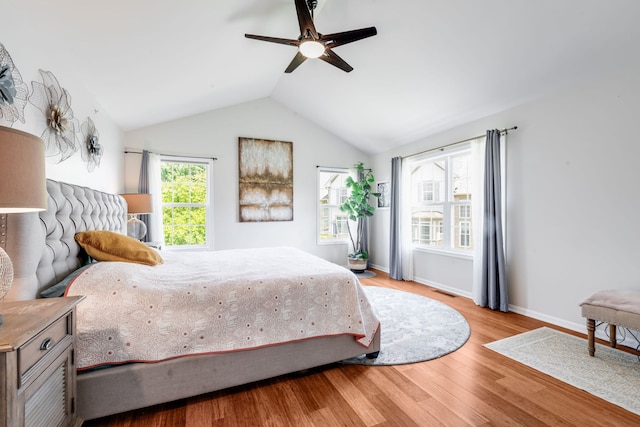 2119 Ivy Ridge Dr Unit 2119, Hoffman Estates, IL 60192 - bedroom featuring wood finished floors, multiple windows, vaulted ceiling, and ceiling fan