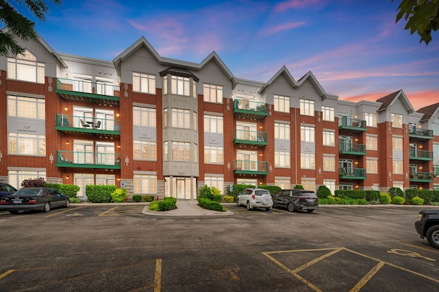 620 Mchenry Rd Unit 102, Wheeling, IL 60090 - property at dusk featuring uncovered parking