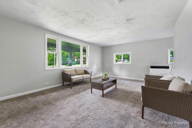 1912 Oakleaf Dr, Mchenry, IL 60050 - living area featuring baseboards, brick wall, and carpet floors