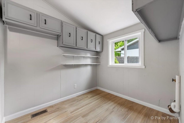 1912 Oakleaf Dr, Mchenry, IL 60050 - empty room featuring light wood-type flooring, lofted ceiling, and baseboards