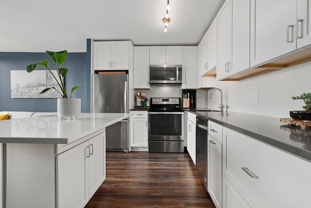 2754 N Hampden Ct Unit 2002, Chicago, IL 60614 - kitchen with appliances with stainless steel finishes, dark wood-type flooring, white cabinetry, dark countertops, and a kitchen island