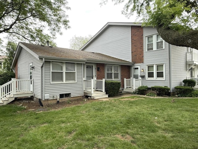 view of front of property with a front yard and roof with shingles