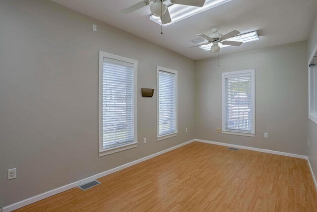 504 E Church St, Champaign, IL 61820 - empty room with a ceiling fan, light wood-style floors, and baseboards