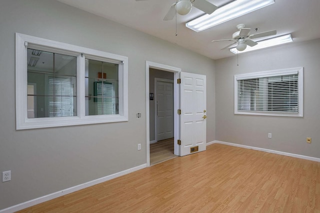 504 E Church St, Champaign, IL 61820 - unfurnished room with a ceiling fan, light wood-style floors, and baseboards