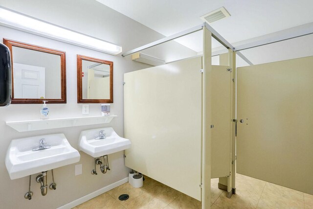 504 E Church St, Champaign, IL 61820 - bathroom with tile patterned floors, a sink, and baseboards