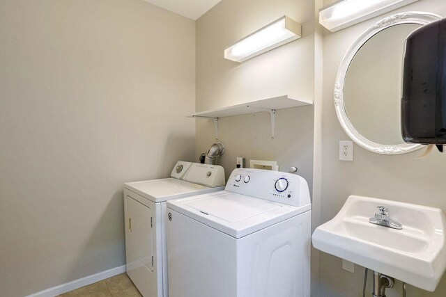 504 E Church St, Champaign, IL 61820 - laundry room featuring separate washer and dryer, baseboards, and light tile patterned floors
