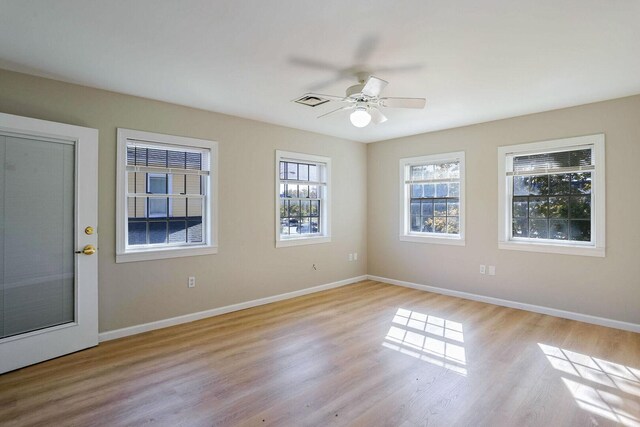 504 E Church St, Champaign, IL 61820 - empty room featuring light wood finished floors, baseboards, and ceiling fan