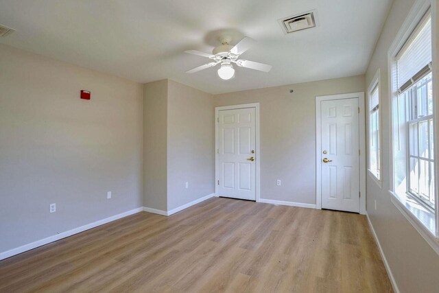 504 E Church St, Champaign, IL 61820 - spare room featuring healthy amount of natural light, a ceiling fan, and baseboards
