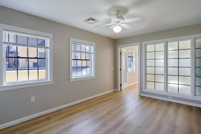 504 E Church St, Champaign, IL 61820 - empty room featuring baseboards, wood finished floors, and ceiling fan