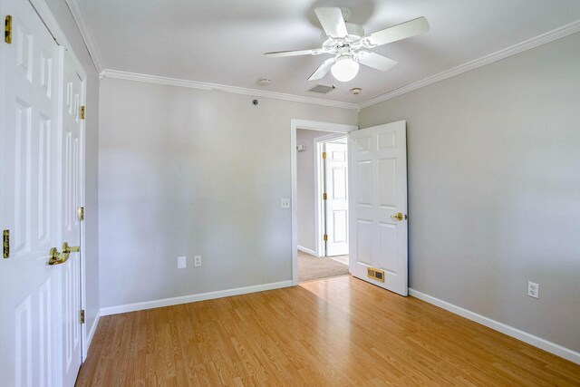 504 E Church St, Champaign, IL 61820 - empty room featuring a ceiling fan, light wood-type flooring, baseboards, and ornamental molding