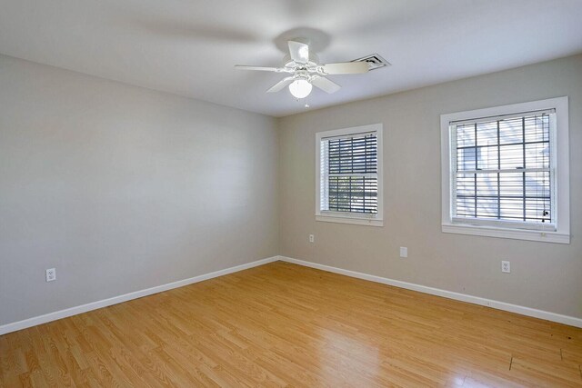 504 E Church St, Champaign, IL 61820 - spare room with light wood-style flooring, baseboards, and ceiling fan