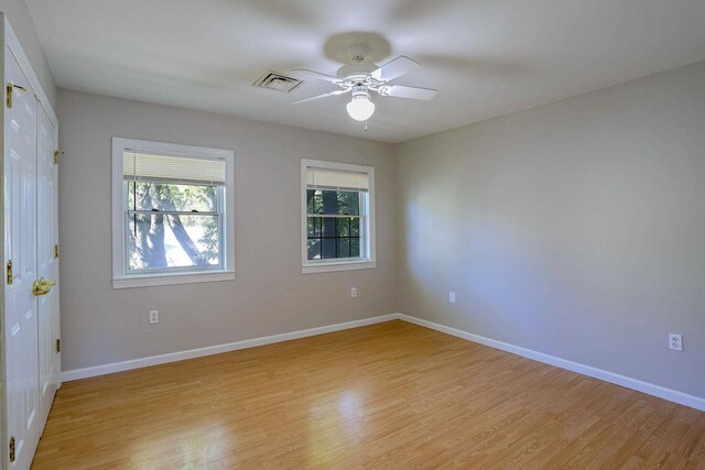 504 E Church St, Champaign, IL 61820 - empty room with light wood-type flooring, ceiling fan, and baseboards