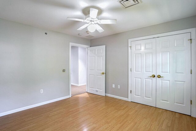 504 E Church St, Champaign, IL 61820 - unfurnished bedroom featuring light wood-style floors, baseboards, a closet, and ceiling fan