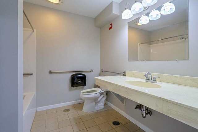 504 E Church St, Champaign, IL 61820 - bathroom featuring tile patterned floors, toilet, baseboards, bathing tub / shower combination, and vanity