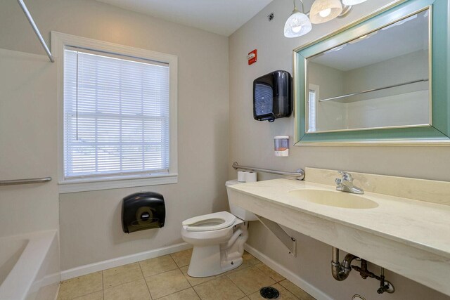 504 E Church St, Champaign, IL 61820 - bathroom with tile patterned floors, baseboards, toilet, and vanity