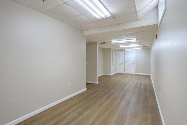 504 E Church St, Champaign, IL 61820 - spare room featuring wood finished floors, a drop ceiling, and baseboards