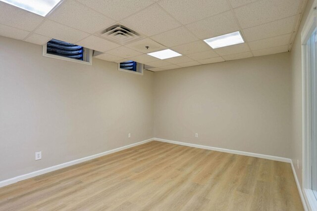 504 E Church St, Champaign, IL 61820 - empty room featuring light wood-style floors, a drop ceiling, baseboards, and fire sprinkler in ceiling