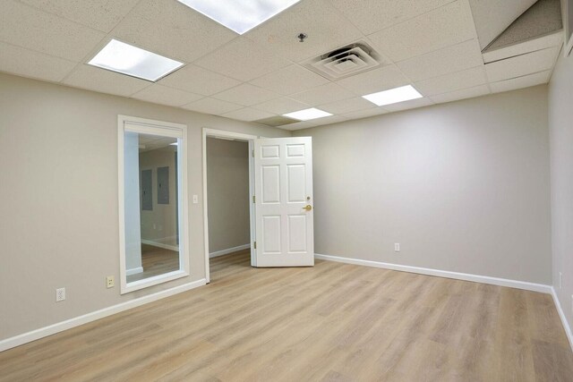 504 E Church St, Champaign, IL 61820 - empty room with light wood-style flooring, a paneled ceiling, baseboards, and a pendent fire sprinkler