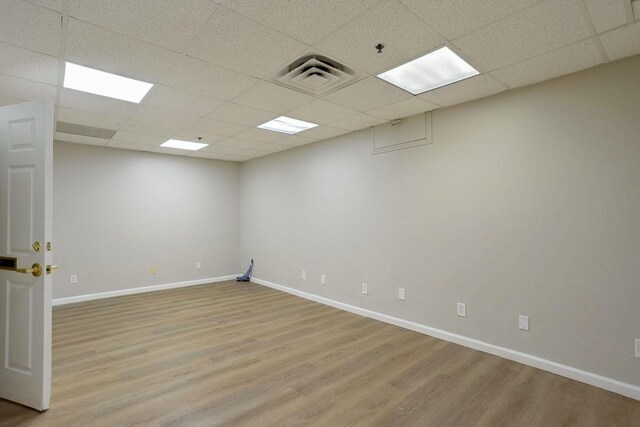 504 E Church St, Champaign, IL 61820 - unfurnished room featuring a paneled ceiling, light wood finished floors, baseboards, and fire sprinkler in ceiling