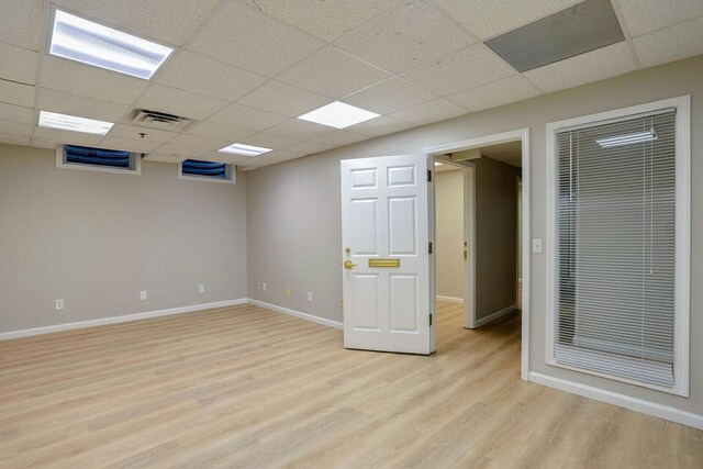 504 E Church St, Champaign, IL 61820 - empty room with light wood-type flooring, a drop ceiling, and baseboards