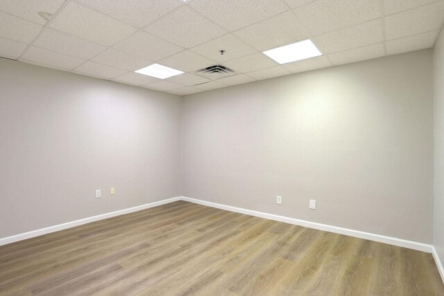504 E Church St, Champaign, IL 61820 - empty room with light wood-type flooring, a paneled ceiling, and baseboards