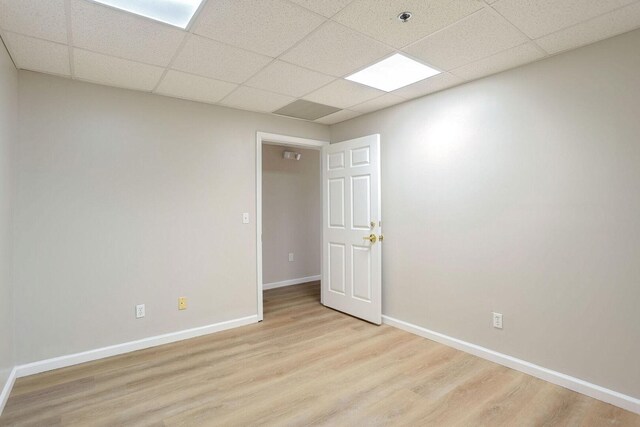 504 E Church St, Champaign, IL 61820 - unfurnished room with light wood-style floors, baseboards, and a paneled ceiling