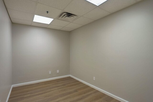 504 E Church St, Champaign, IL 61820 - unfurnished room with wood finished floors, a paneled ceiling, baseboards, and a pendent fire sprinkler