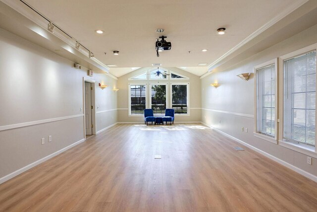 504 E Church St, Champaign, IL 61820 - unfurnished living room featuring ceiling fan, vaulted ceiling, baseboards, wood finished floors, and crown molding