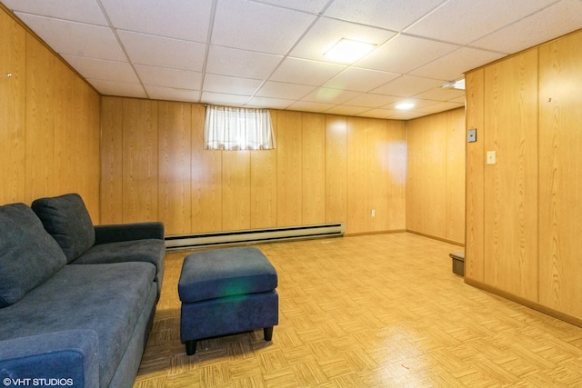 613 E 3rd St Unit 4, Lockport, IL 60441 - living area featuring baseboard heating, wood walls, and a paneled ceiling